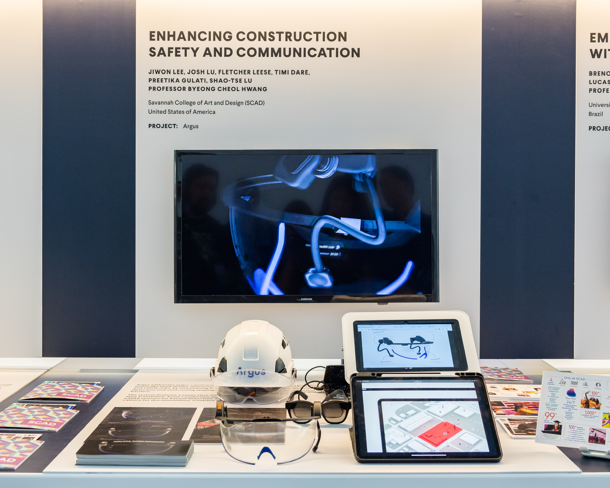 Argus exhibition display with the physical visor and companion apps at Prototypes for Humanity